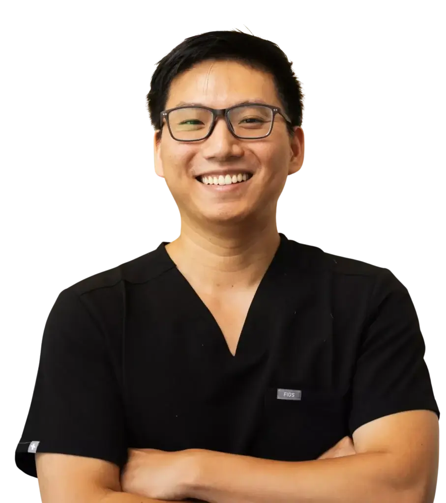 Comfort-focused dentist at Aster Smiles posing with arms crossed in Cypress, Tx