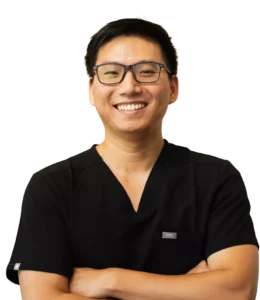 Comfort-focused dentist at Aster Smiles posing with arms crossed in Cypress, Tx